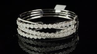 Multi row diamond bracelet, entwined rows comprising three rows of diamond daisy clusters and two