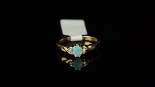 Three stone opal and diamond ring, mounted in hallmarked 9ct yellow gold, central oval opal, with