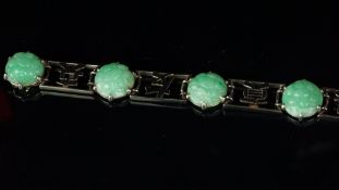 Carved jade bracelet mounted in unmarked white metal, with six Chinese character panels and six