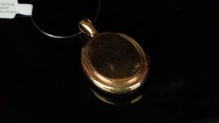 Oval locket in unmarked yellow metal, dimensions 45mm x 28mm, gross weight approximately 11.4
