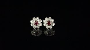 Ruby and diamond flower earrings, central round cut ruby surrounded by round brilliant cut diamonds,