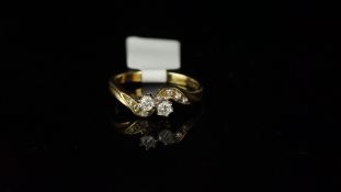 Diamond crossover ring, mounted in hallmarked 9ct yellow gold, two central brilliant cut diamonds,