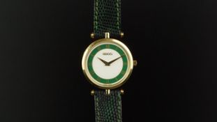 LADIES' GUCCI WRISTWATCH, circular dial with green detail, Roman numerals, gold plated case with