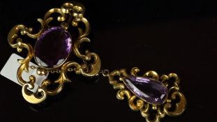 Amethyst drop brooch, mounted in unmarked yellow metal, set with one oval amethyst and one pear