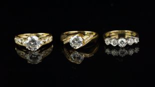Three cubic zirconia rings, one set in 9ct yellow gold and two set in 14ct yellow gold