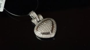 Diamond set heart shaped pendant mounted in white metal stamped 18k to the bale, diamonds micro claw