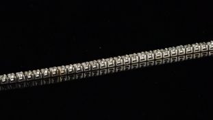 Diamond tennis bracelet, sixty-three round brilliant cut diamonds, weighing an estimated 0.055ct