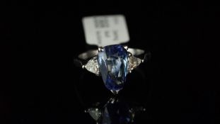 Ceylon sapphire and diamond three stone ring, mounted in white metal, partial French eagle's head