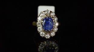 Ceylon sapphire and diamond oval cluster ring, mounted in yellow metal stamped with the French