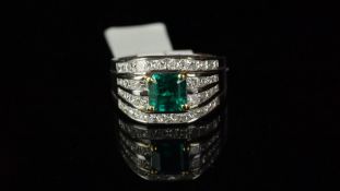 Emerald and diamond dress ring, central octagonal cut emerald, four claw set, in yellow metal,