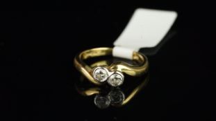 Two stone diamond crossover ring, two round brilliant cut diamonds, mounted in 18ct yellow gold,