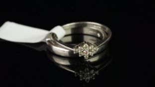 Two platinum rings, comprising a nine stone diamond cluster ring and a shaped wedding band,