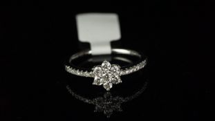 Diamond cluster ring, central daisy shaped cluster, claw set with seven round brilliant cut