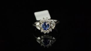 Sapphire and diamond fancy cluster ring, central oval sapphire weighing an estimated 1.08ct,