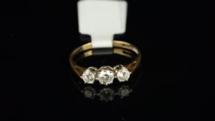 Three stone cubic zirconia ring, set in 9ct yellow gold, finger size M, gross weight approximately