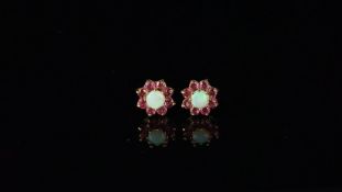 Pair of opal and ruby cluster ear studs, mounted in hallmarked 9ct yellow gold, with posts and