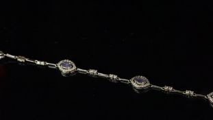 Tanzanite and diamond bracelet, five marquise shaped cluster sections each set with one tanzanite