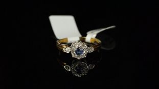 Sapphire and diamond round cluster ring, central round sapphire claw set and surrounded by eight