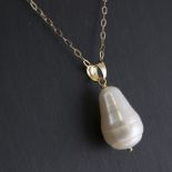 A cultured pearl pendant necklace. The freshwater cultured pearl of baroque form suspended from a