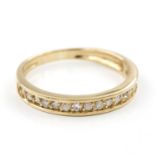 A diamond set half eternity ring. The 18kt yellow gold ring set to the front with a row of brilliant