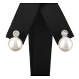 A pair of South Sea cultured pearl and diamond earrings. The saltwater cultured pearls suspended