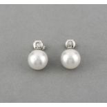 A pair of South Sea pearl and diamond earrings. The Australian cultured pearls suspended below