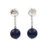 A pair of lapis lazuli and diamond set earrings. The polished cross shaped surmounts centrally inset