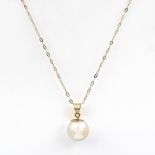 An Akoya cultured pearl pendant necklace. The white Akoya pearl suspended from a 18kt yellow gold