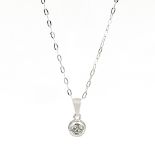 A diamond set pendant necklace. The collet mounted brilliant cut diamond suspended from a tapered