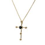A sapphire and diamond set cross pendant. The Latin cross centrally set with a claw set round cut