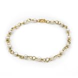 A cultured pearl set bracelet. The 18kt yellow gold bracelet spaced at regular intervals by Akoya