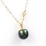 A Tahitian pearl pendant necklace. The grey Tahitian cultured pearl of baroque form, suspended