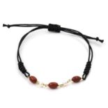 A coral and cultured pearl bracelet. The bracelet set to the front with a trio of oval coral