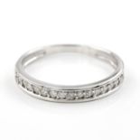 A diamond set half eternity ring. The 18kt white gold ring set to the front with a row of