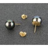 A pair of Tahitian pearl stud earrings. The grey Tahitian pearls to post and butterfly back