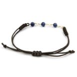 A sapphire and cultured pearl bracelet. The bracelet set to the front with a trio of spherical