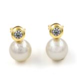 A pair of Akoya pearl and cubic zirconia earrings. Each saltwater cultured pearl suspended below a