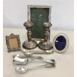 Collection of silver items includes candle sticks picture frames & cutlery etc