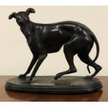 An animalier bronze modelled as a greyhound with gily metal inset, hatched oval base 6 1/2 in lonh