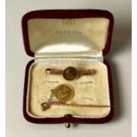 2 American Gold $1 coins. One mounted on a stick pin dated 1859.