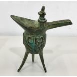 Bronze Chinese Jue of tripod form, the cylindrical relief decorated with stylised taotie mask motifs