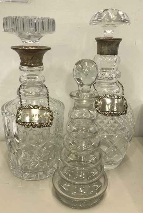 3 Glass decanters 2 with hallmarked silver rims with silver decanter labels all Hallmarked