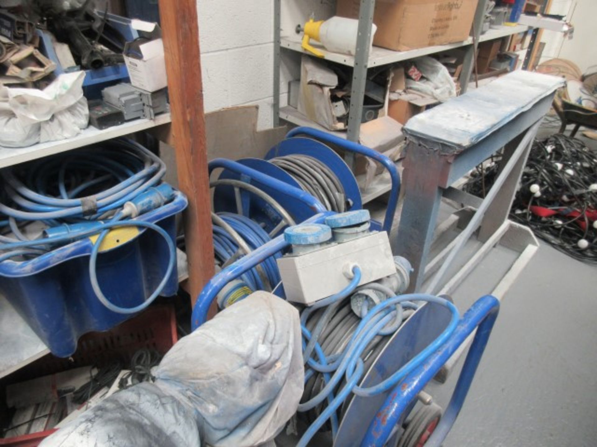 Three reels of heavy duty 240v cable with sockets & quantity of 240v cables and sockets on rack.