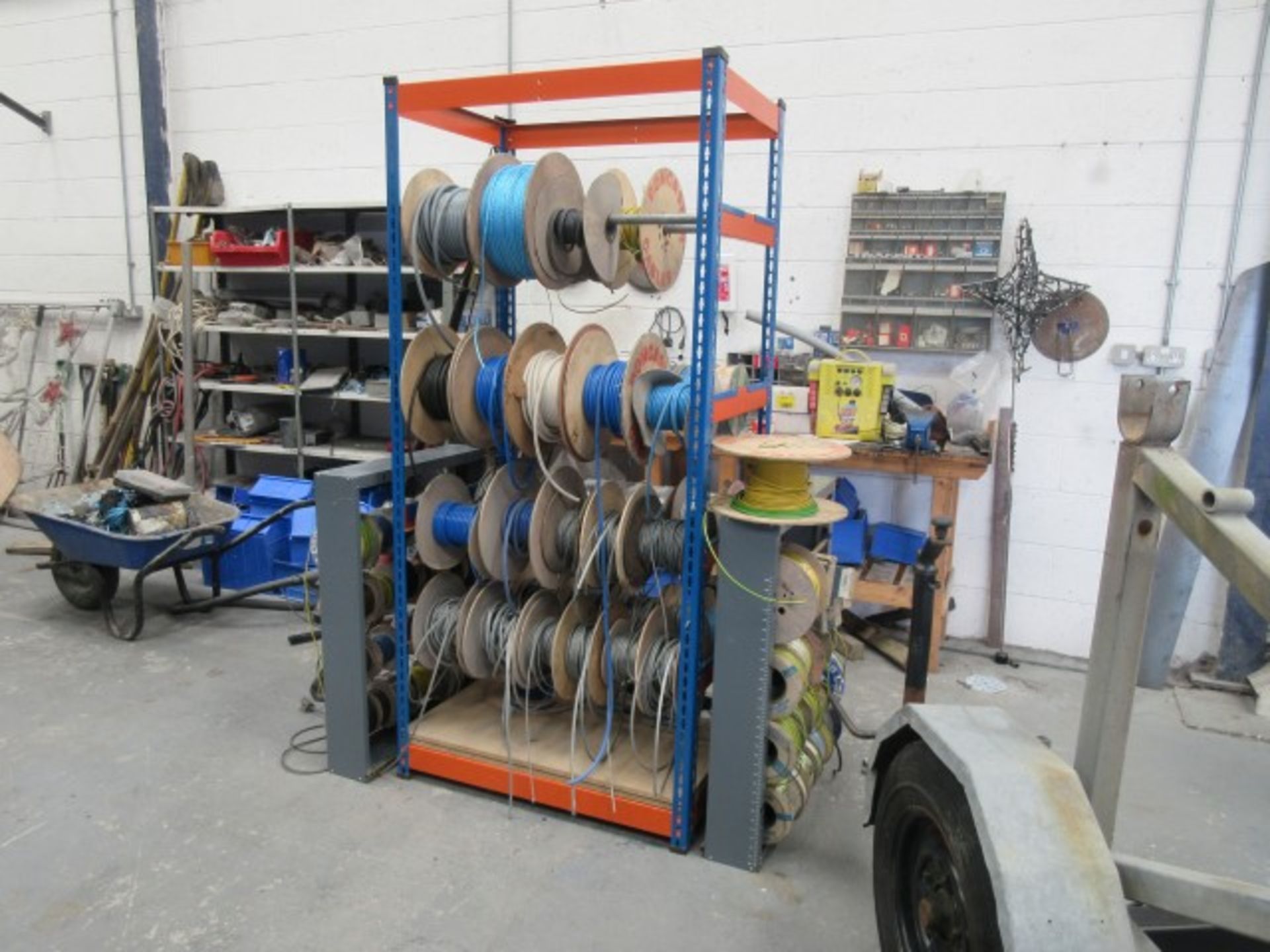 Quantity of reels of electric cable & wire rope one, including racks.