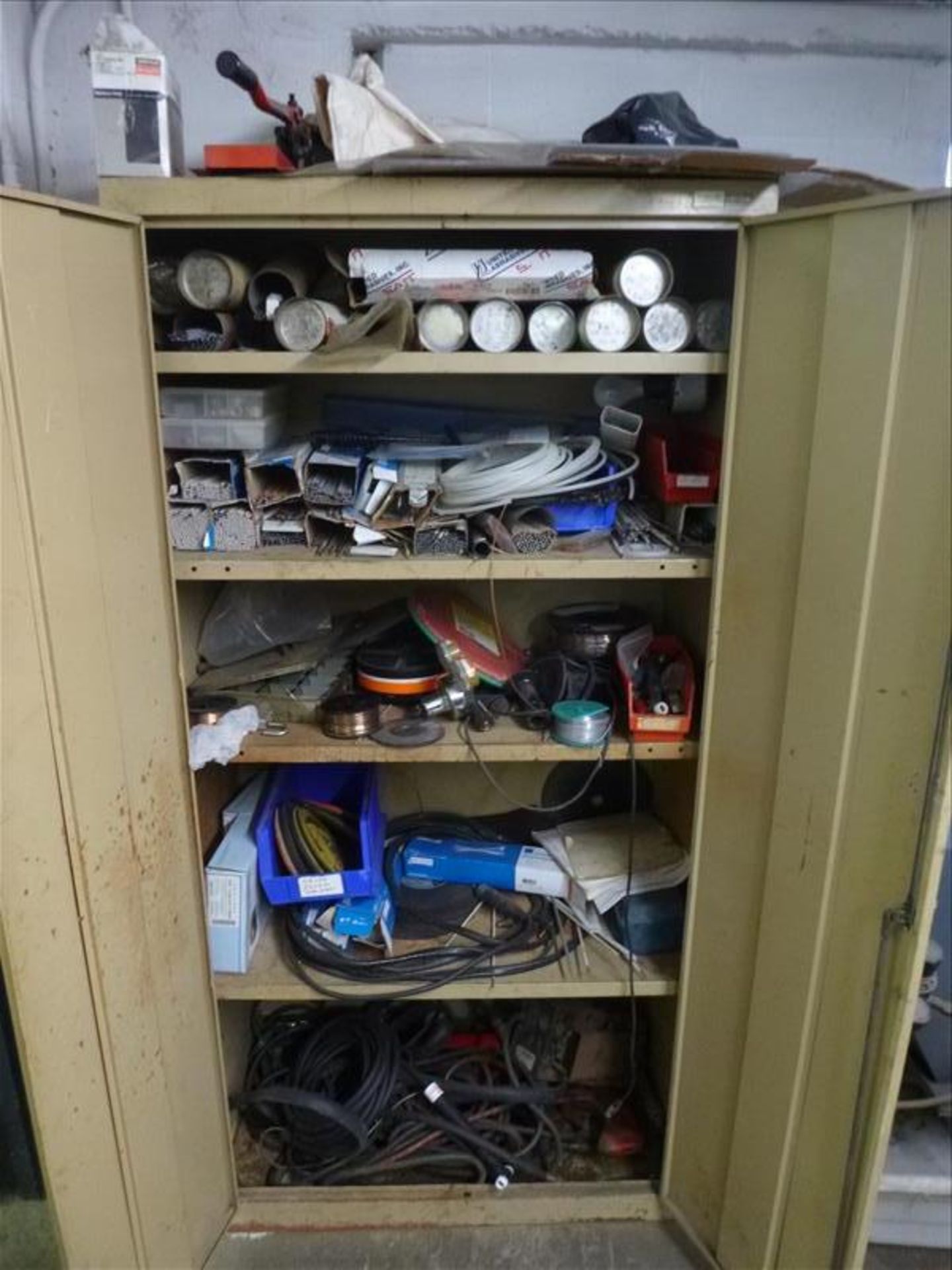 2-door cabinet c/w contents: welding rods, etc.(maint. shop, south basement)