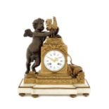 A late 19thc. French Louis XVI style patinated bronze, gilt bronze, white marble mantel clock