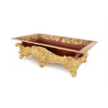 A red and gilt decorated tôleware tray on a 19th century giltwood base