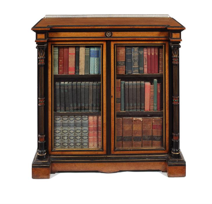 A mid Victorian amboyna and ebonised inverted breakfront side cabinet by Gillow & Co.