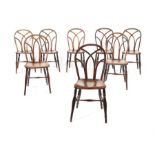 A matched set of eight George IV ash, figured elm and beech Gothic Windsor chairs