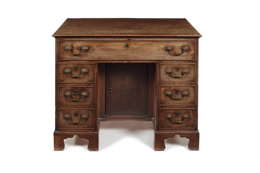 A George II mahogany and crossbanded kneehole dressing table/ desk